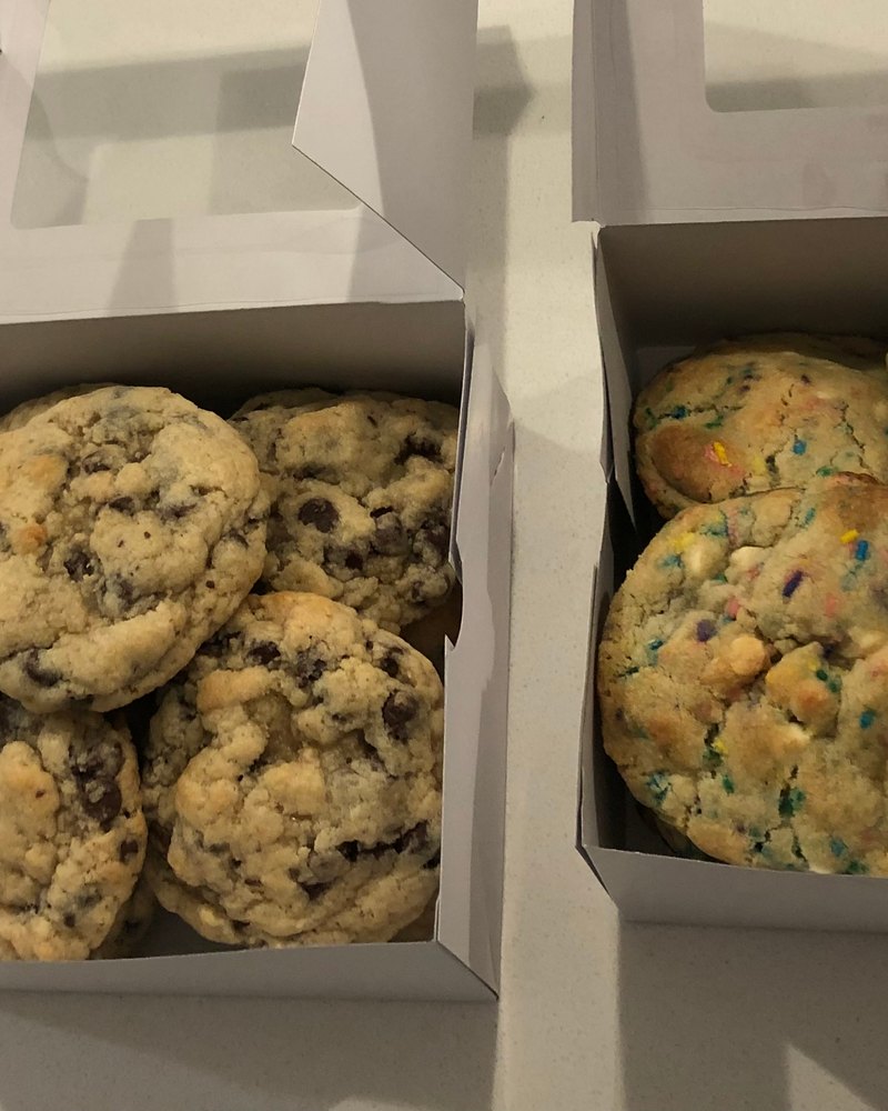 Two open boxes of six, chocolate chip and birthday cake