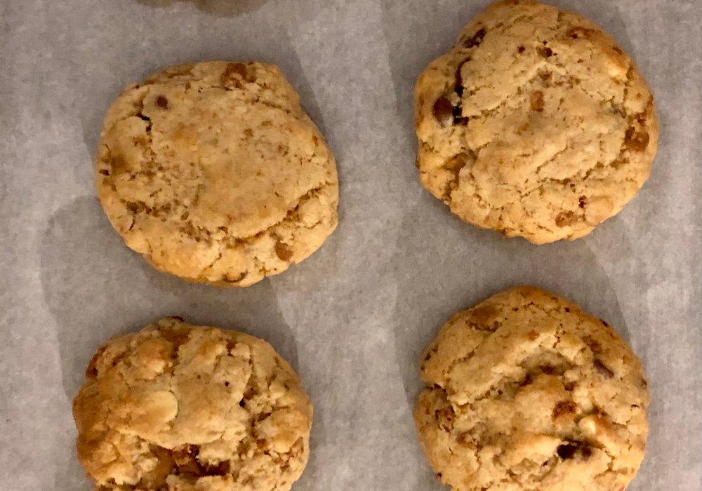 A tray of cookies fresh out of the oven on parchment
